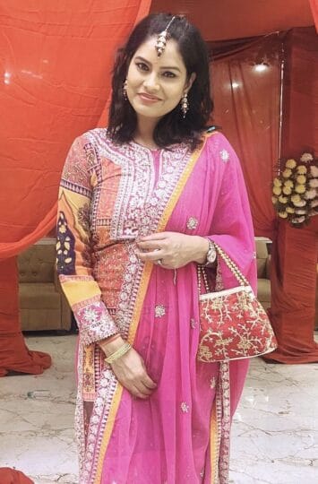 Elegant Suman Singh wearing a vibrant pink saree with intricate embroidery.
